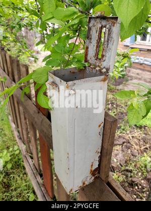Old mailbox on a wooden fence close up Stock Photo