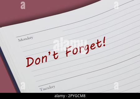 Dont Forget diary reminder appointment open on desk Stock Photo