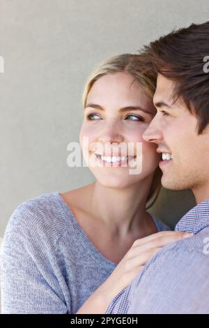 I dont ever want to wake up from this daydream. an affectionate young couple standing against a gray background. Stock Photo