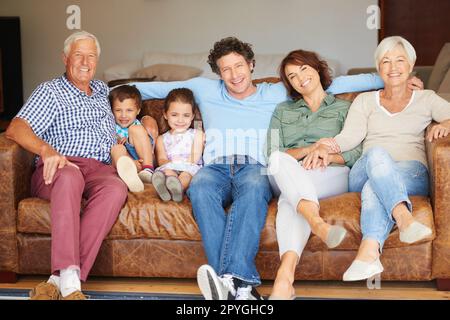Spending some quality family time together. a happy multi-generational family sitting together on a sofa. Stock Photo