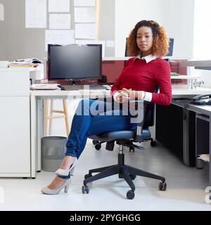 Design is my game and Im winning. Portrait of a young designer sitting at her workstation in an office. Stock Photo