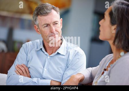 Hes being stubborn. a mature married couple having an argument at home. Stock Photo