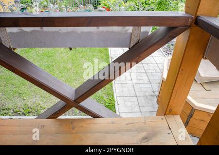 Close-up of the fence on the porch of the terrace, view from the inside. blurred summer garden background Stock Photo