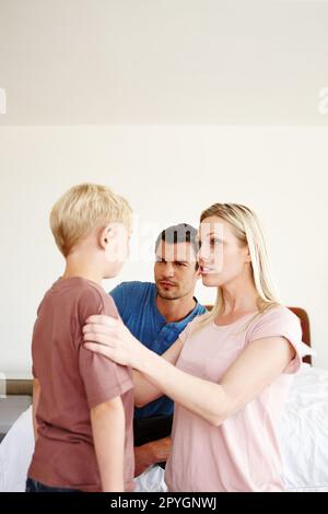 Working together as a team to discipline their son. A mother and father disciplining their son. Stock Photo