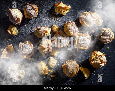 Yellow mini tarts dusted with powdered sugar Stock Photo