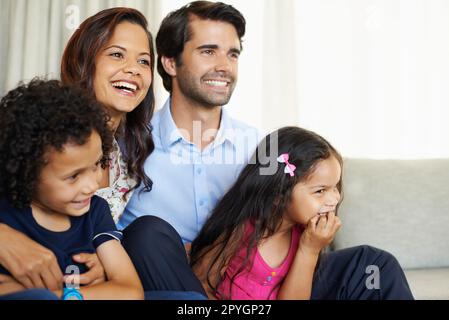 Enjoying some family time. A happy young family enjoying some time spent sitting together. Stock Photo