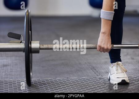 Barbell, woman hands and weightlifting exercise for fitness, workout and sports challenge in gym. Closeup female athlete, body builder and heavy weights for deadlift, wellness and power Stock Photo