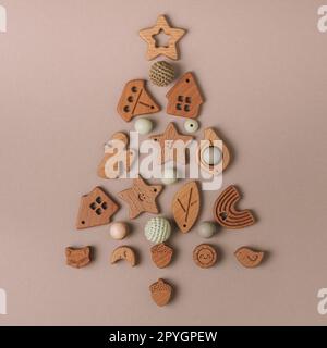 Little Santa stands next to an Armenian wooden Christmas tree toy