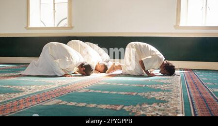 Islamic salah prayer. Muslim men praying in a modern mosque. Ramadan or ...