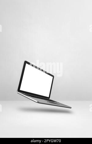 Blank computer laptop floating over a white background. 3D isolated illustration. Vertical template Stock Photo
