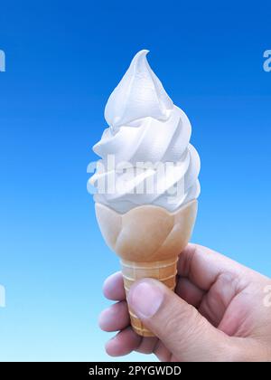 Hand holding blue ice cream cone Stock Photo - Alamy