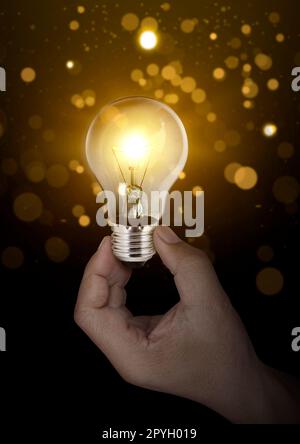 Idea concept with innovative technology, Brainstorming creativity, idea thinking with Young Asian Businessman holding light bulbs symbol Stock Photo