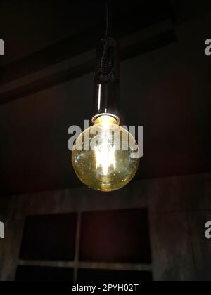light bulb glowing in dark Stock Photo