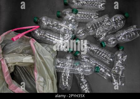 Recycling and ecology concept. Sorting household waste captured from above, flat lay. Grey concrete background empty plastic bottles Stock Photo