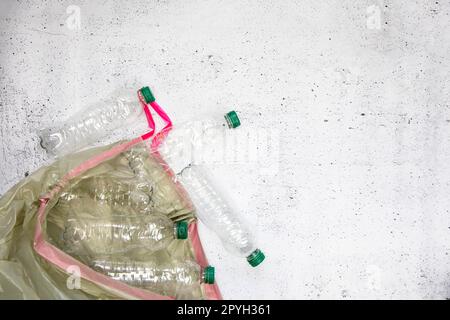 Recycling and ecology concept. Sorting household waste captured from above, flat lay. White concrete background empty plastic bottles Stock Photo