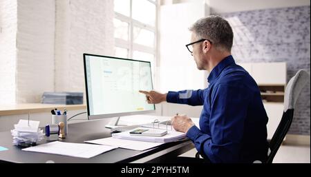 Accountant Using E Invoice Software At Computer Stock Photo