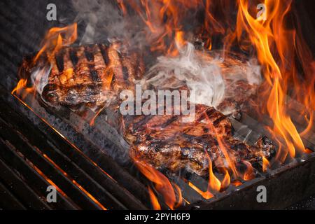 Searing and smoking ribeye steaks on grill Stock Photo