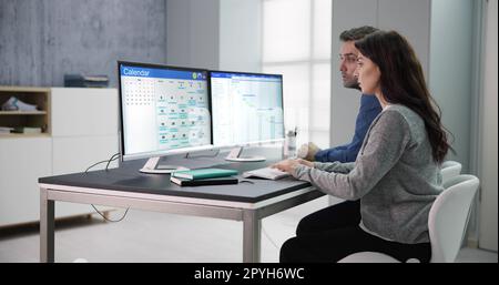 Young Businesspeople Analyzing Gantt Chart Stock Photo