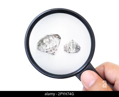 Gem stones. Jeweller checking polished diamond. Carat size diamonds. Diamond trading and dealing. Loose diamond grading. Precious stones Stock Photo