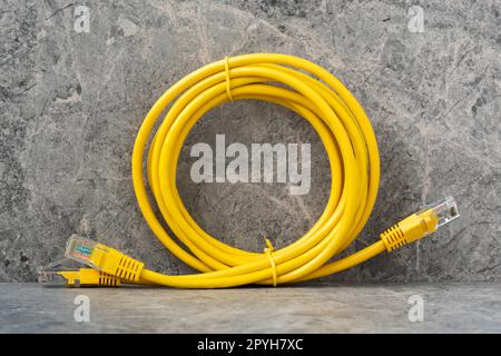 Internet cables RJ45 on the stone background Stock Photo