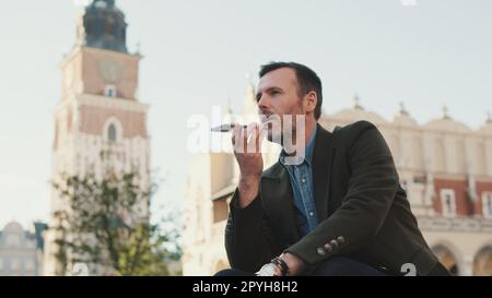 Man sends voice message on old town background Stock Photo