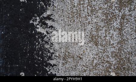 Concrete wall with black and white stripe of paint. Carelessly brushed parts, translucent gray plaster through the applied oil paint. Grunge background with empty space. Copy space Stock Photo