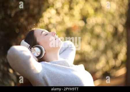 Relaxed woman resting listening audio Stock Photo