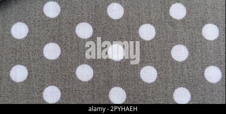 fabric white polka dots on a gray background, smoothed flat surface Stock Photo