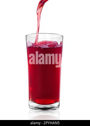 the flow of pomegranate juice being poured into glass isolated on white background Stock Photo