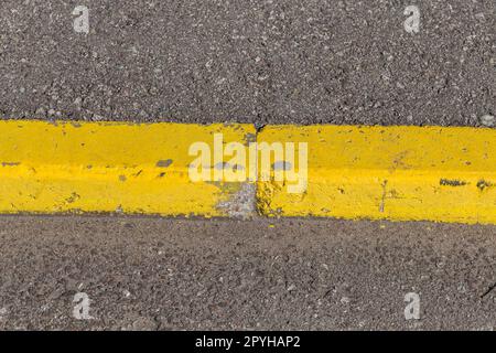 Yellow curb stone border Stock Photo