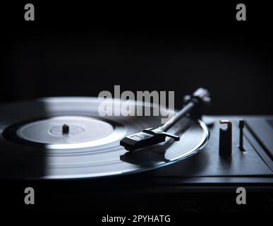 Retro gramophone vinyl player over black background with copyspace. Stock Photo