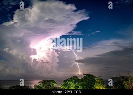 Amazing sunset over the stormy sea thunder and lightning in the background Stock Photo