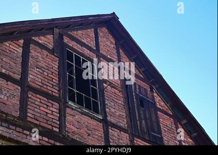 Old facade with broken windows Stock Photo