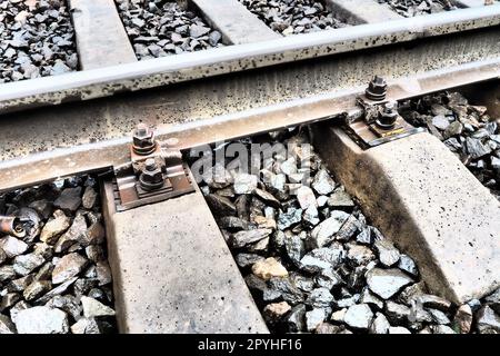 Railways. Metal steel rails and wooden sleepers. Rivets and fasteners on the railroad. Stony backfill of railway tracks. Station Nyrki, Karelia. Stock Photo