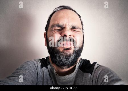 Funny man with the beard making expressions Stock Photo