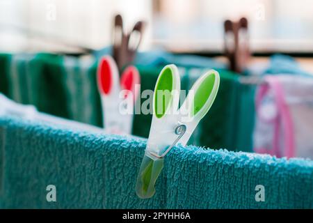 Laundry pins on ropes at home Stock Photo