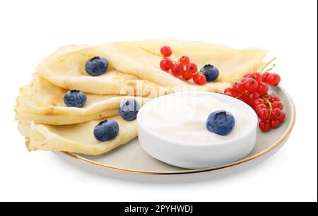 Delicious crepes with natural yogurt, blueberries and red currants on white background Stock Photo