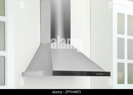 Modern range hood on white brick wall in kitchen Stock Photo