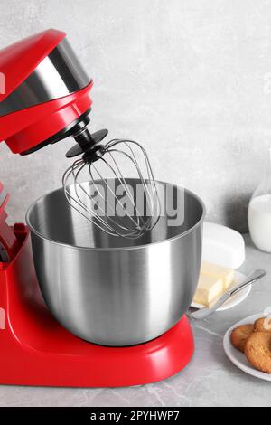 Modern red stand mixer, croissant and cookies on wooden table Stock Photo -  Alamy