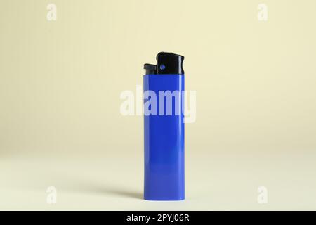 Stylish small pocket lighter on beige background Stock Photo
