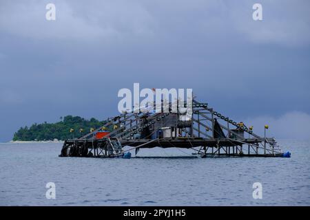 Baskets with fishing nets on small pier, Santa Giulia beach