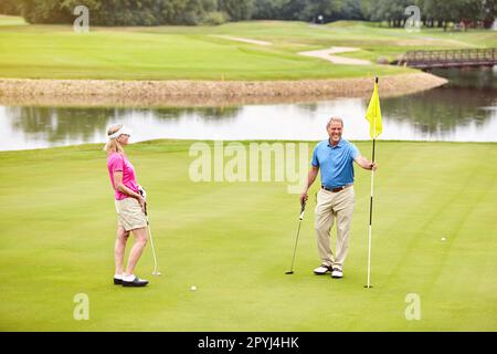 Playing golf is something we do together. a mature couple out playing golf together. Stock Photo