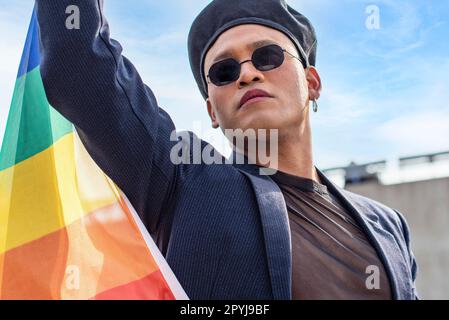 Gay activist holding a LGBT rainbow flag. Concept of Pride. Pride month. Stock Photo