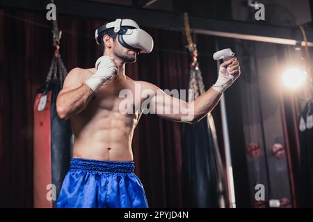 Professional boxer wear virtual reality headsets to engage in immersive boxing workouts simulations while practicing their punching techniques. Live, Stock Photo