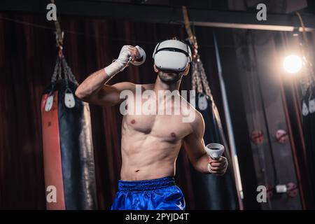 Professional boxer wear virtual reality headsets to engage in immersive boxing workouts simulations while practicing their punching techniques. Live, Stock Photo