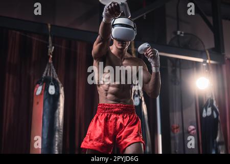 Professional boxer wear virtual reality headsets to engage in immersive boxing workouts simulations while practicing their punching techniques. Live, Stock Photo