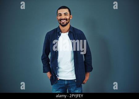Professional and confident. Studio portrait of a confident man posing against a gray background. Stock Photo