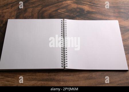 photo clean sheets in a notebook on a wooden background Stock Photo