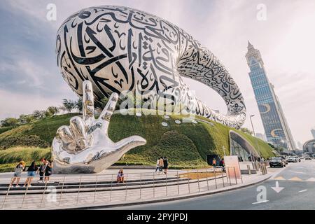 17 January 2023, Dubai, UAE: Famous Future museum in shape of Crescent with arabic inscriptions and hand sculpture Stock Photo