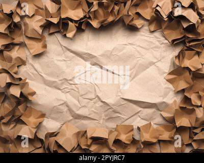 Frame made from recycled paper packaging material on a crushed recycled paper Stock Photo